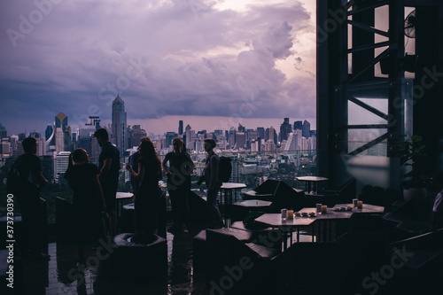 Photography Silhouettes of people talking on terrace of skyscraper