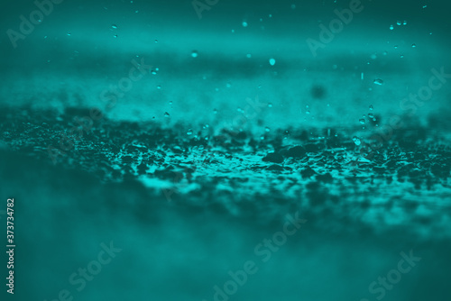 Rain water drops on rain water. heavy rain falling and water splashing useful background.