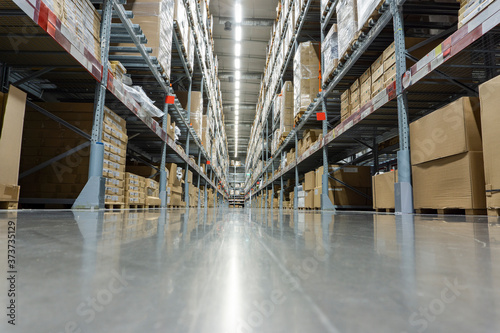 Rows of shelves with boxes in modern warehouse. Warehouse Goods Stock Concept.