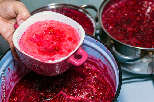 Making raspberry jam. Raspberry jam foam.