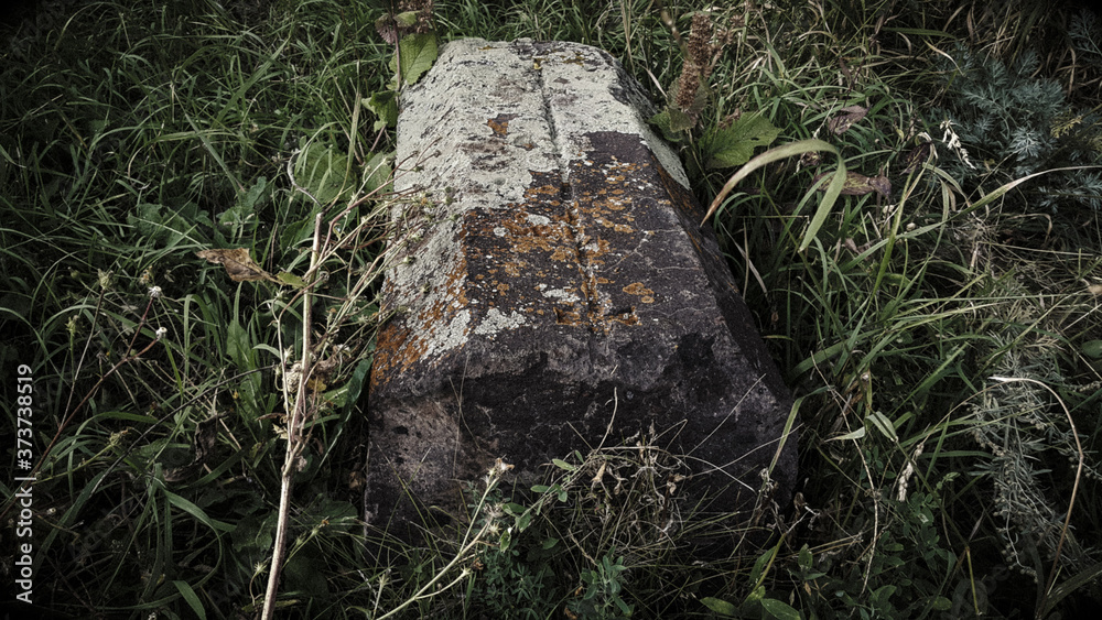 Obraz premium Ancient Armenian cemetery. Christian Grave of 1800. Burial place. Carved tombstone. Very old threaded stones. Memorial to the memory of the old world. Historical memory.