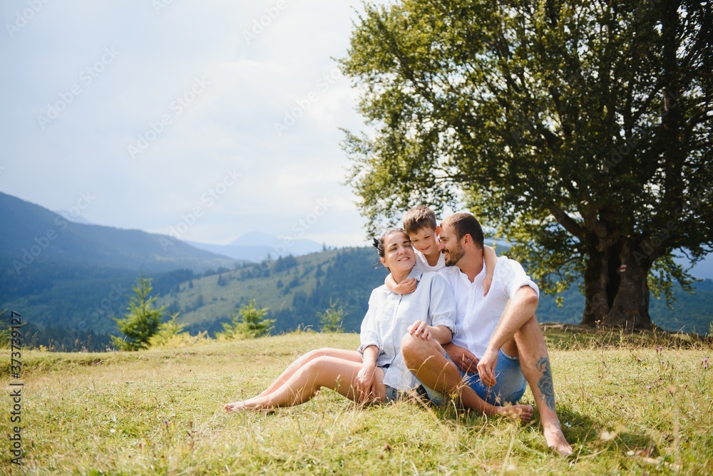 Young family with child resting on a mountain. vacation in the national park Young family with child resting on a mountain. vacation in the national park