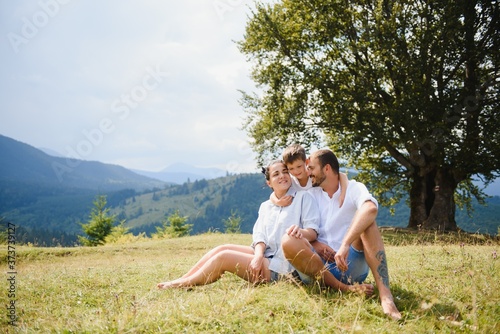 Young family with child resting on a mountain. vacation in the national park