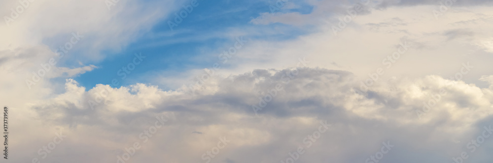 Panorama of blue sky with white clouds in the evening
