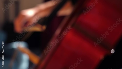 Close up of a young woman playing violoncello