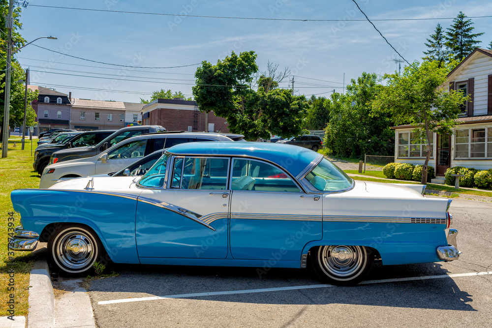 An old 1954 car parked in a Port Dover street, Ontario, Canada, completely reformed and painted in original colors.