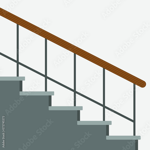 Staircase with railing on a gray wall background