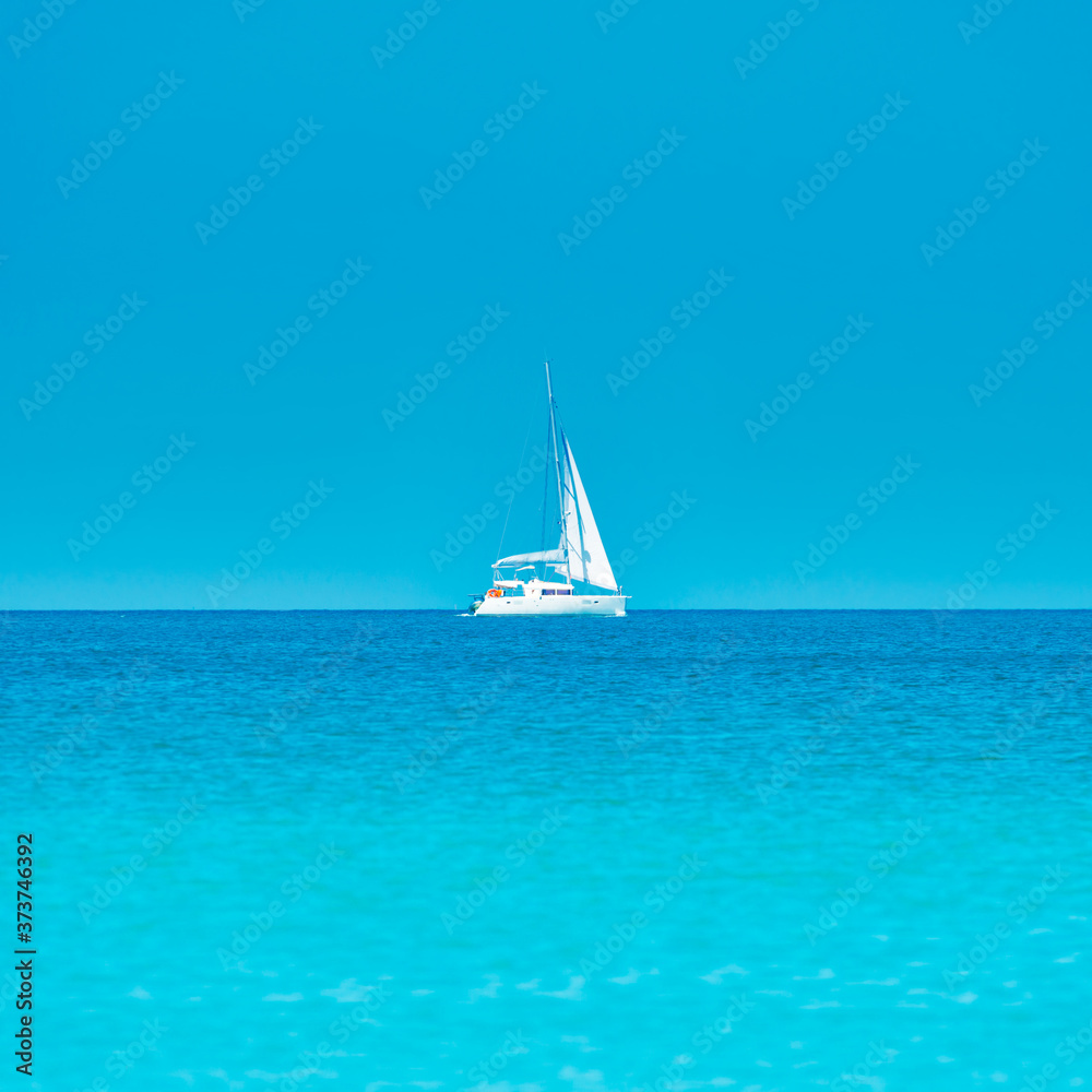 White yacht on blue sea with blue water and sky