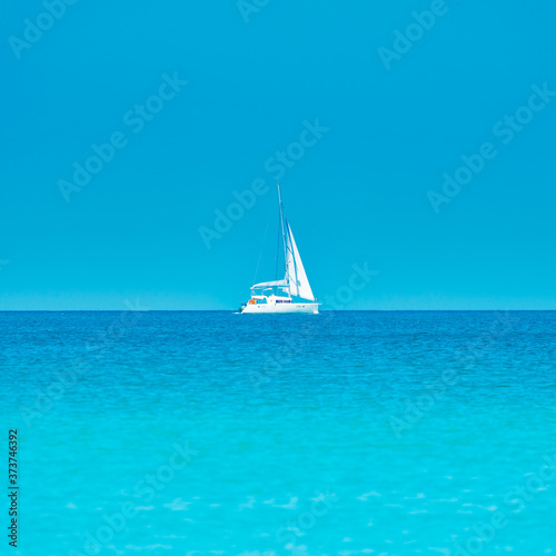 White yacht on blue sea with blue water and sky