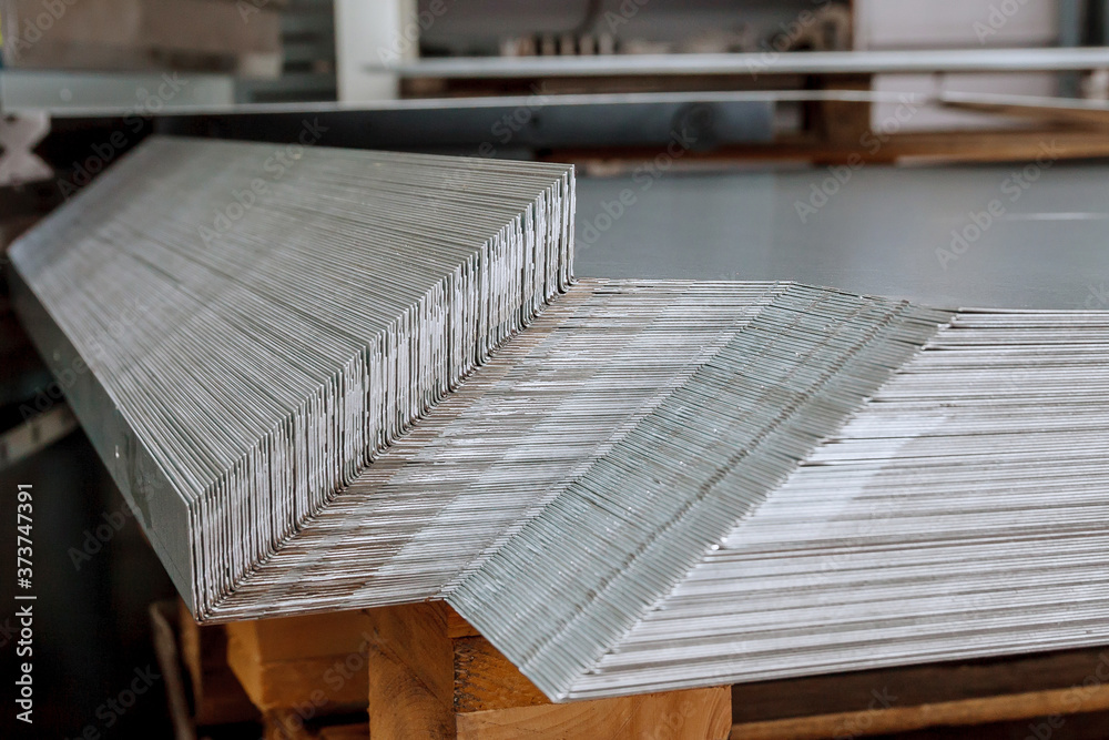 Sheet metal products are stacked on a pallet after a bending process. Sheet metal products are stacked on a pallet after a bending process.