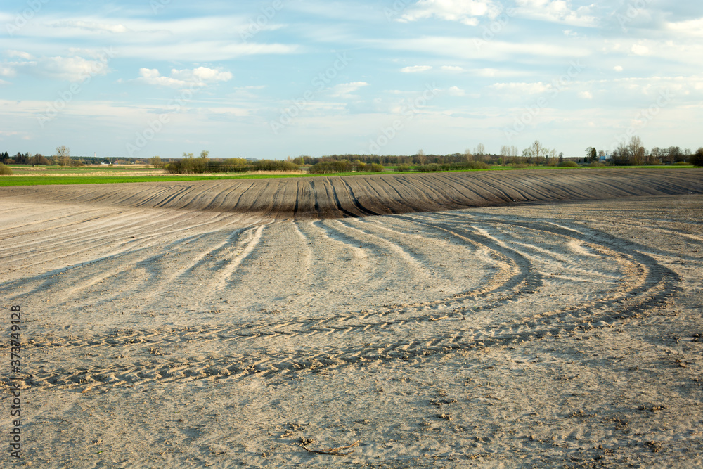 Traces of the tractor in the ploughed field Traces of the tractor in the ploughed field