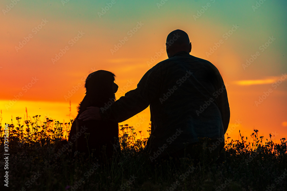 silhouette of a man and a dog, two greatest friends until the death, with dog devotion