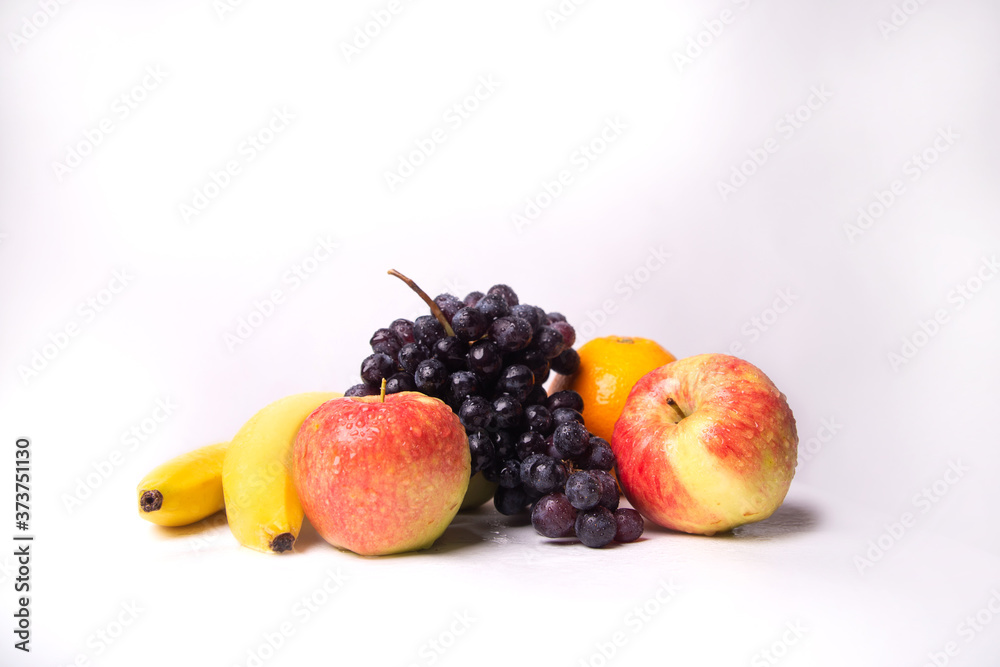 Still life of fruits on a white background, banana, apple, grapes Still life of fruits on a white background, banana, apple, grapes