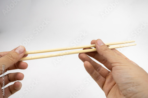Woman using chopsticks, bamboo chopsticks for asian food