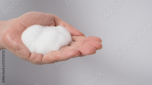 Hands washing gesture with foaming hand soap on white background.