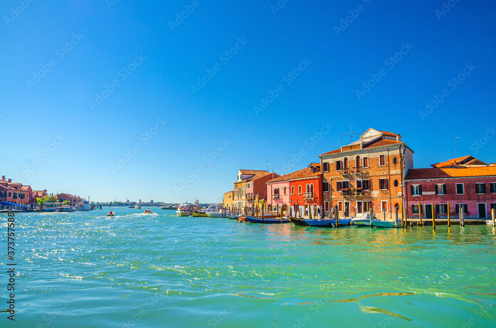 Murano islands with water canal, boats, colorful traditional buildings, Venetian Lagoon