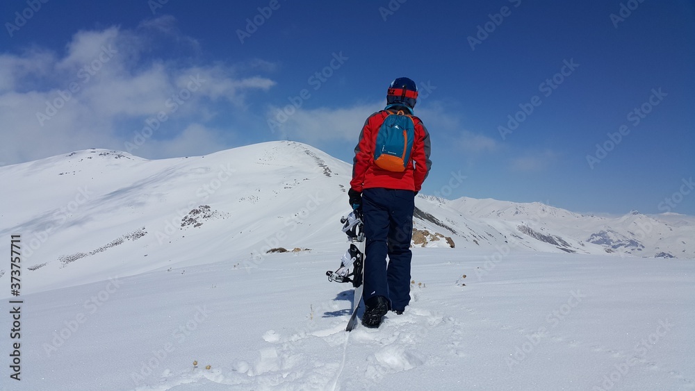 a young skier skiing on the mountain, winter season and snow landscape
