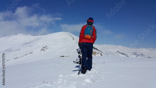 a young skier skiing on the mountain, winter season and snow landscape 