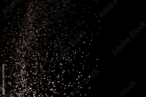 White dust on a black background, selective focus.