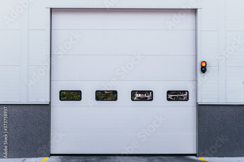 White entrance gate door to the warehouse