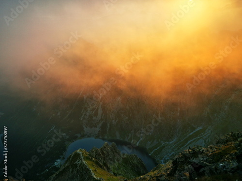 Hazy mountain peaks at sunrise. Poland Tatra Mountains. Red sunrise.