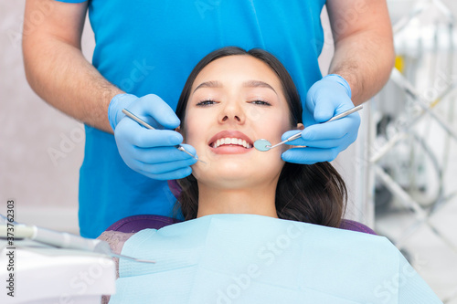 dentist examines the patients teeth at the dentist.