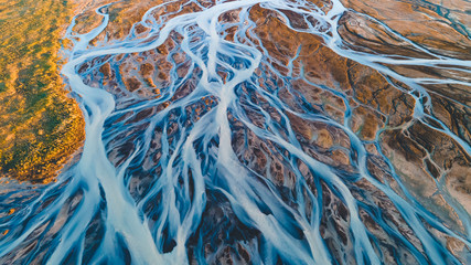 A glacial rivers from above. Aerial photograph of the river streams from Icelandic glaciers. Beautiful art of the Mother nature created in Iceland. Wallpaper background high quality photo