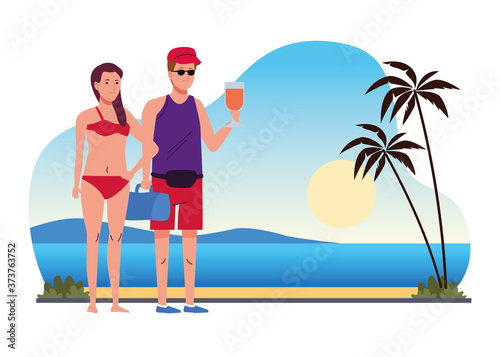 young couple wearing swimsuits drinking cocktails on the beach scene