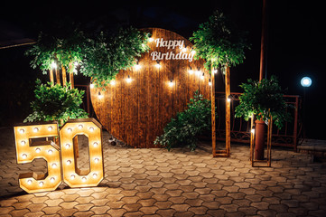 Round wooden arch, photo zone for a photo shoot for a 50th anniversary man