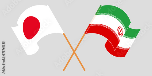 Crossed and waving flags of Iran and Japan