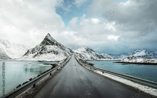 Olstind Mount and asphalt road. Lofoten islands, spring time, Norway photo