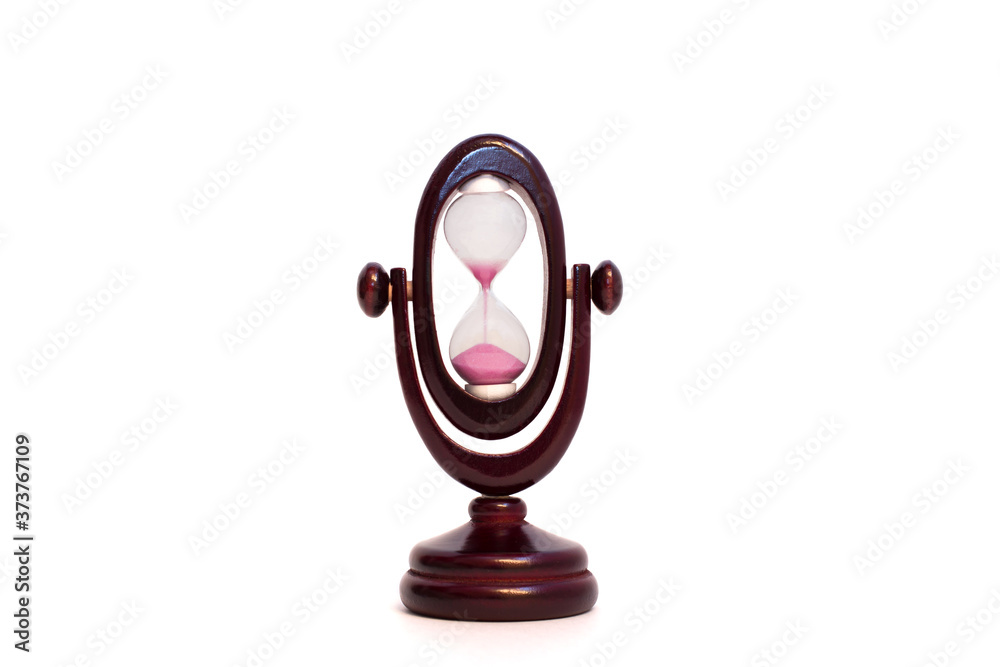 Image of hourglass at the end of the countdown. Time is running out. Old sandglass of mahogany color. Isolated on white backround. Image of hourglass at the end of the countdown. Time is running out. Old sandglass of mahogany color. Isolated on white backround.