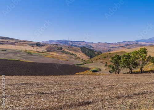 Central Sicilian farm lands with deserts and wind farms in the background