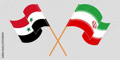 Crossed and waving flags of Iran and Syria