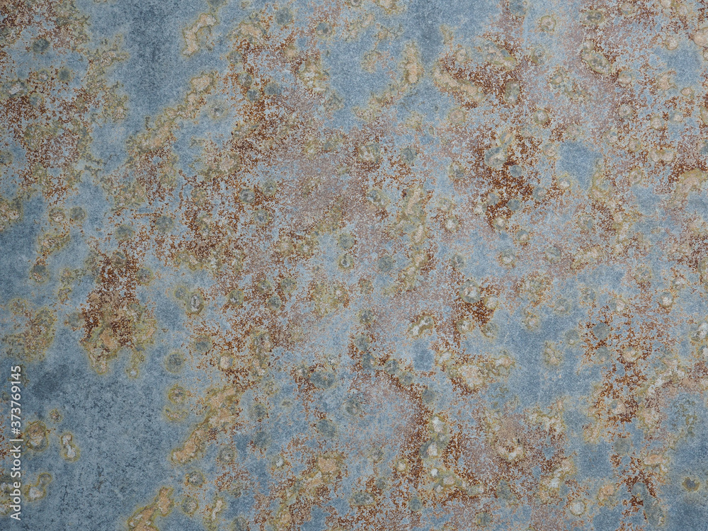 Texture of oxidized metal with brass and aqua patina. Rusty metal surface with streaks of rust. Rusty corrosion. Brown, grey, blue and orange rust and dirt on enamel. Corroded metal background.