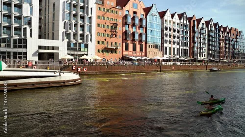 Gdansk, North Poland - August 15, 2020: People doing leisure activities such as kayaking in motlawa river over a weekend at city center main square