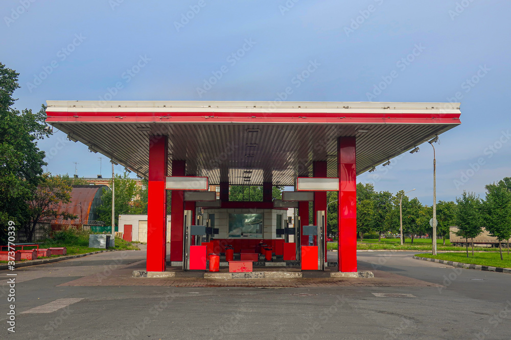 gas station for vehicles without customers under blue skies and lots of surveillance cameras on the roof