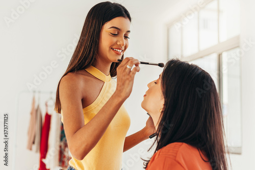 Young latin make-up artist in her makeup room. Small business owners concept. photo