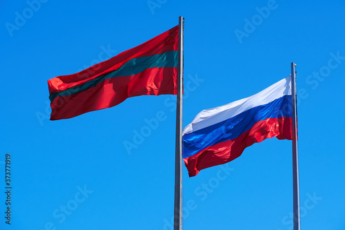 the national flag of Transnistria and Russia against the sky