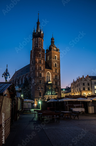 A Christmas market and St. Mary's Church in Cracow at blue hour