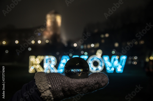 Glowing inscription Kraków in the night, Cracow