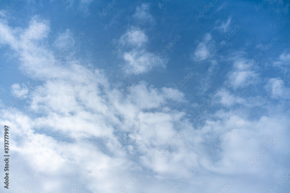 .White cumulus clouds against the background against blue on a blue background.