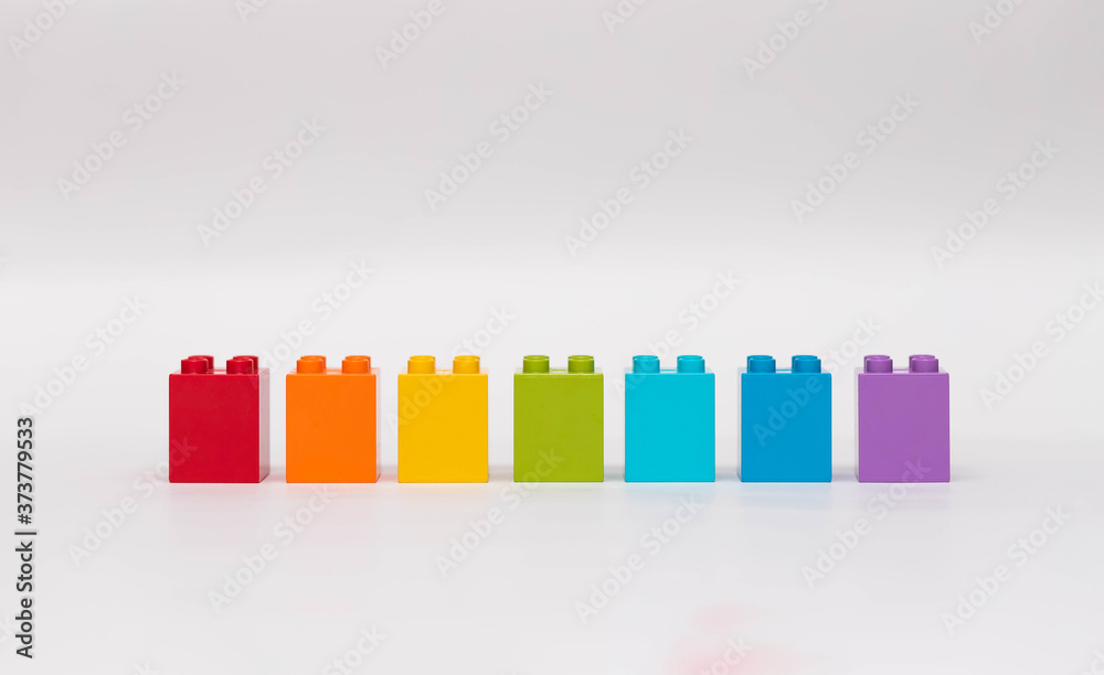 Plastic building blocks isolated on white background.
Blocks of colors of the rainbow.
Early learning. Educational toys