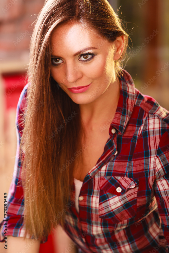 Young fashionable woman posing during sunny day. Young fashionable woman posing during sunny day.