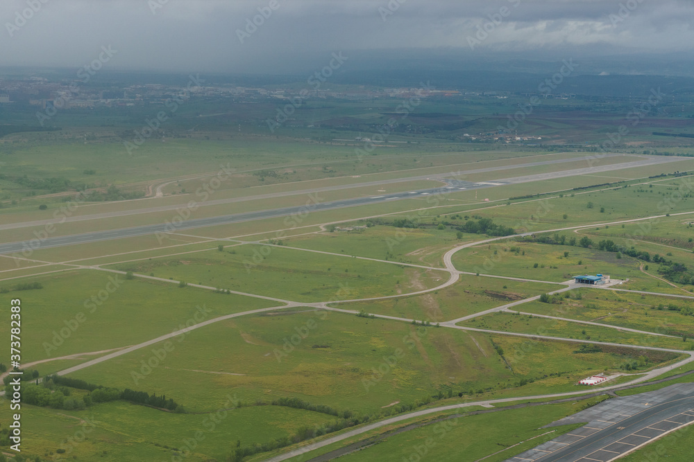 Aerial view of one of the runways at Adolfo Suarez airport and surroundings on a cloudy day.