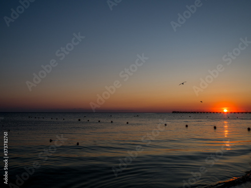 Fototapeta Naklejka Na Ścianę i Meble -  The sun sets in the sea. Bright sea sunset on the South coast.