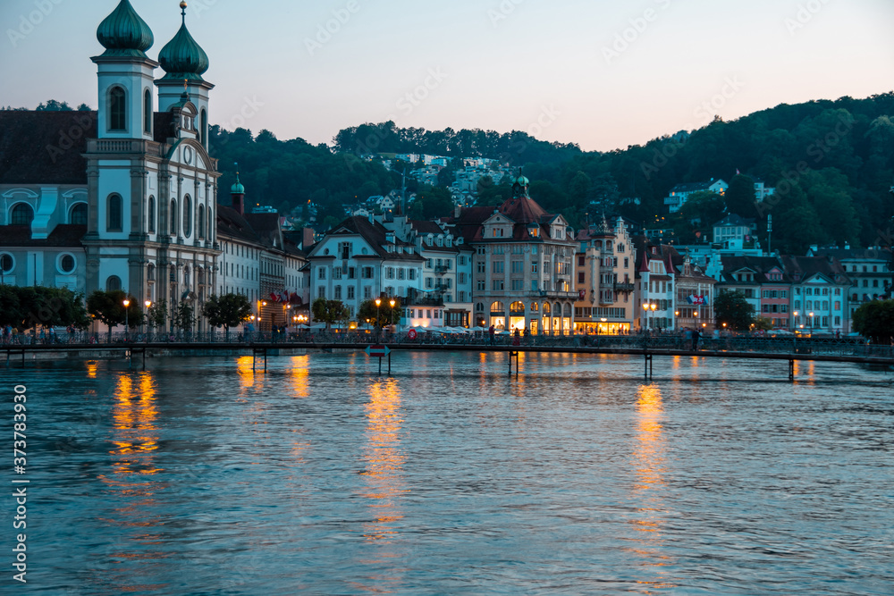 Historic city center of Lucerne, bridge and river Reuss. Nice summer evening.