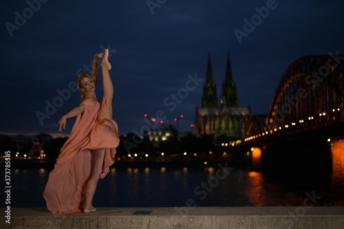 Photography A beautiful ballet dancer ballerina outdoors ,Ballerina dancing on the bridge  in Cologne City