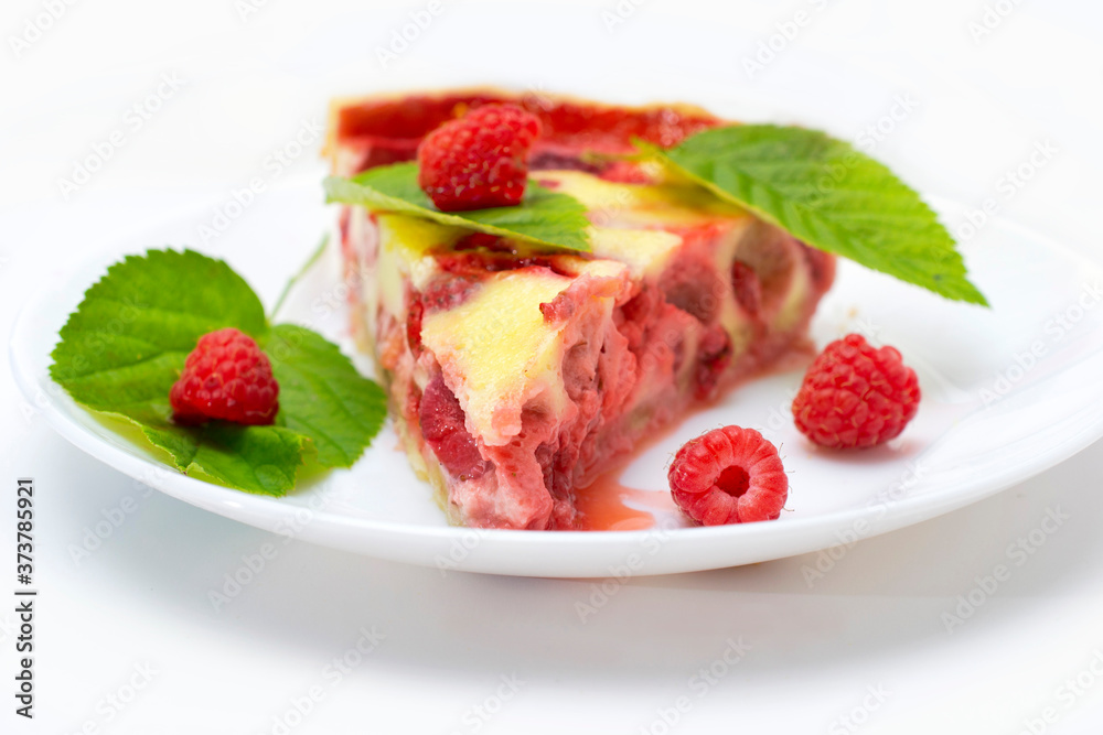 raspberry piroke on a white table, garnished with raspberries and raspberry leaves. raspberry piroke on a white table, garnished with raspberries and raspberry leaves.