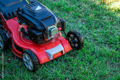 lawn mower on the grass with copy space, agricultural and gardening machinery